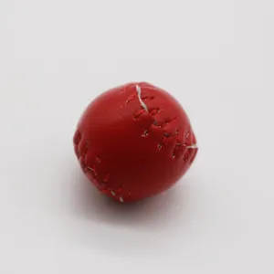 Detail view of a red mini baseball keychain with realistic white stitching