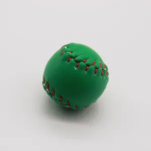 Detailed close-up of a green mini baseball keychain with vibrant red stitching