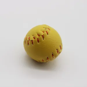 Macro view of a mini yellow softball keychain pendant with red stitching detail