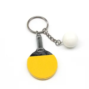 Miniatuur tafeltennisracket sleutelhanger met witte bal en geel rubberen oppervlak