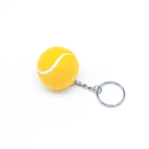 Detalle del llavero de pelota de tenis amarilla con aro de metal y textura de felpa suave