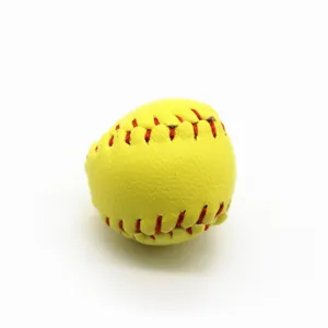 Detail view of a mini yellow softball keychain pendant with realistic red stitching