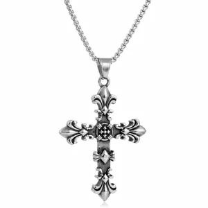 Close-up of a retro Gothic cross pendant with an antique silver fleur-de-lis design
