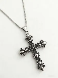 Detailed close-up of a vintage gothic cross pendant necklace with antique silver fleur-de-lis