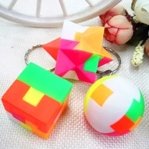 Close-up of colorful 2.5cm puzzle cube, ball, and star shape plastic keychains for kids