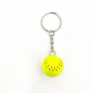 Close-up of mini yellow softball keychain with red stitching and silver metal ring