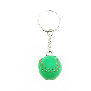 Close-up of a 2cm mini green baseball keychain with vibrant red stitching detail