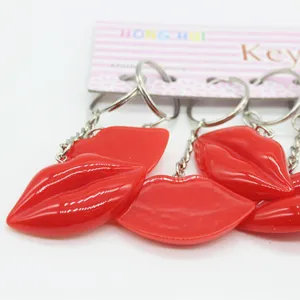 Close-up of vibrant red lip-shaped resin keychains with shiny silver metal rings