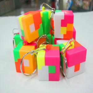 Close-up of 2.5cm colorful puzzle cube keychains with metal rings for children gifts