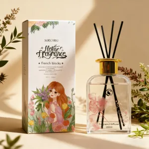 Reed diffuser set with pink dried flowers, black sticks and glass bottle for home fragrance use.