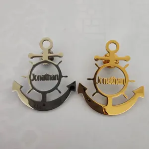 Detailed view of personalized stainless steel anchor brooches with name cutout design.
