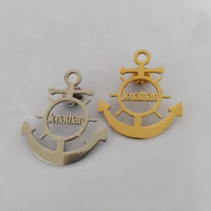 Close-up of stainless steel anchor and helm brooch pins in gold and silver tones