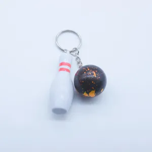 Detailed mini bowling keychain featuring a white pin and speckled black ball on silver ring