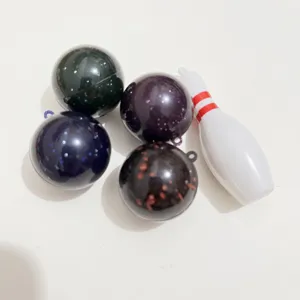 Detailed close-up of colorful glittery mini bowling balls and a white bowling pin