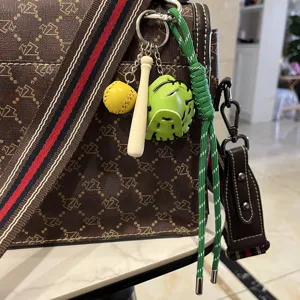 Baseball keychain with mini bat, glove, and green nylon rope charm for bags.
