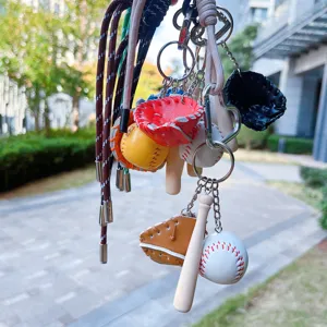 Detailed view showing a cluster of colorful baseball keychains with nylon ropes and mini bats.
