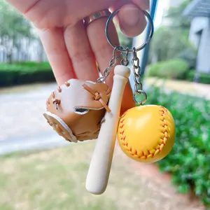 Detailed view of sports keychain featuring mini baseball glove, wooden bat, and yellow ball.