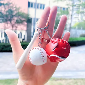 Detailed view of mini baseball keychain set featuring a red glove, white bat, and ball