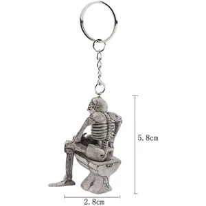 Detail view of skeleton sitting on toilet keychain with 5.8cm height dimension label
