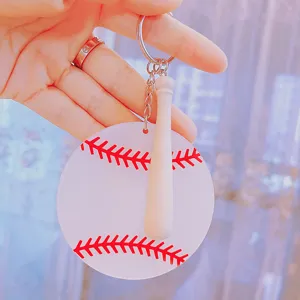 Detailed view of a baseball keychain with an acrylic disk and a wooden bat.