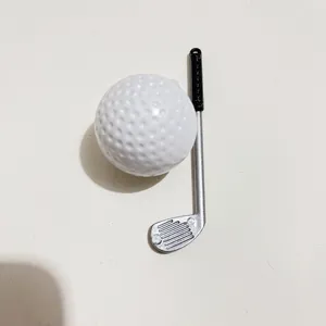 Close-up of a miniature golf ball and silver club accessory with realistic textures.