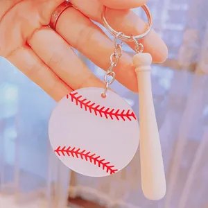 Close-up of acrylic baseball keychain with mini wooden bat and red stitch detail