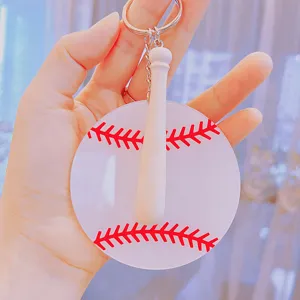 Close-up of acrylic baseball keychain with a mini wooden bat charm held in hand
