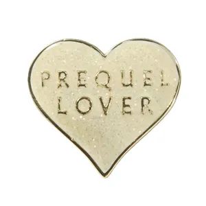 Cream heart shaped glitter enamel pin with PREQUEL LOVER gold text badge