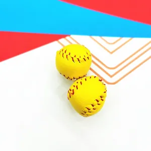 Macro view of miniature yellow softball pendants with realistic red stitching detail