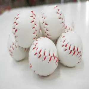 Close-up macro view of mini white baseball craft pendants featuring classic red stitching
