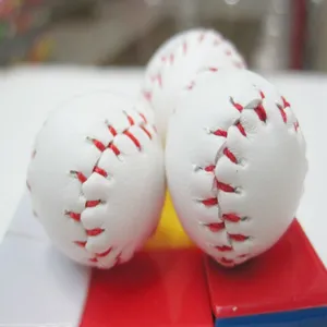 Close-up detail of mini baseball keychains with classic red stitching on white faux leather