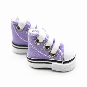 Close-up detail of 3.5cm purple mini canvas doll shoes featuring white laces and rubber sole.