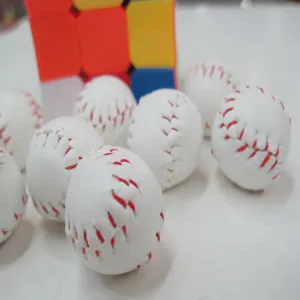 Close-up detail of mini white baseball keychain pendants with realistic red stitching