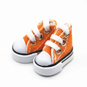 Detailed shot of 3.5cm orange miniature canvas sneakers for dolls and keychains.