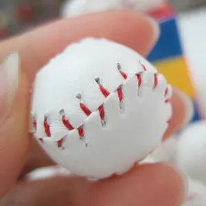 Close-up detail of a white mini baseball pendant with realistic red stitching.