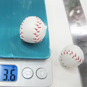 Detailed view of mini baseball showing weight of 3.6g on a digital scale