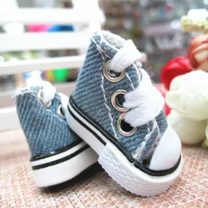 Detail macro view of 3.5cm mini blue denim canvas shoes for dolls and keychains