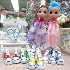 Detail view of colorful 3.5cm mini doll canvas shoes and cute keychains for dolls.