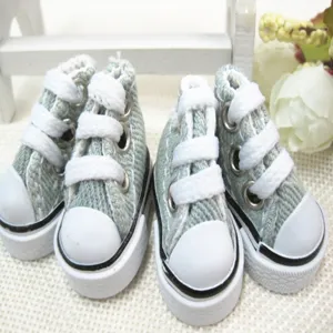 Macro detail of light blue 3.5cm mini canvas shoes for dolls and keychain charms