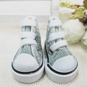 Close-up view of 3.5cm miniature canvas shoes for dolls and keychains in light green