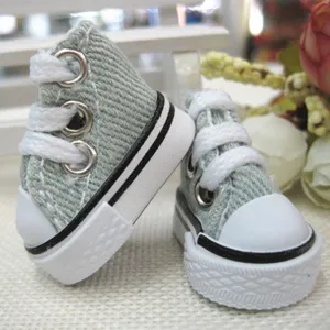 Macro detail of 3.5cm mini denim canvas shoes for dolls, perfect for doll accessories.