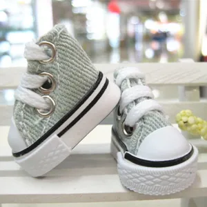 Detail view of 3.5cm mini light green canvas shoes for dolls and keychains.