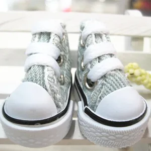 Close-up of 3.5cm mini light blue canvas doll shoes with white laces and thick soles.