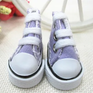 Macro detail view of 3.5cm mini purple canvas shoes for dolls and keychain accessories.