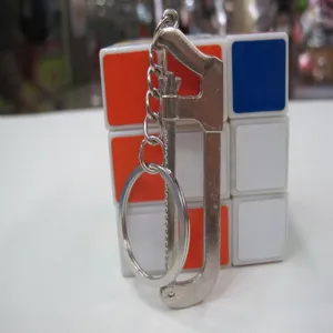 Close-up of a miniature metal hacksaw keychain tool with a polished silver finish