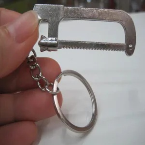 Macro view of miniature stainless steel handsaw keychain tool