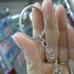 Detailed macro view of a silver stainless steel split ring and chain for keychains
