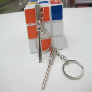 Detail view of miniature silver metal flathead and Phillips screwdriver keychains.