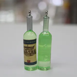 Vue détaillée de deux breloques en forme de bouteille de vin vert pour porte-clés DIY