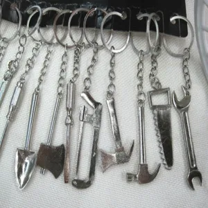 Miniature metal tool keychain set including shovel, axe, and wrench designs